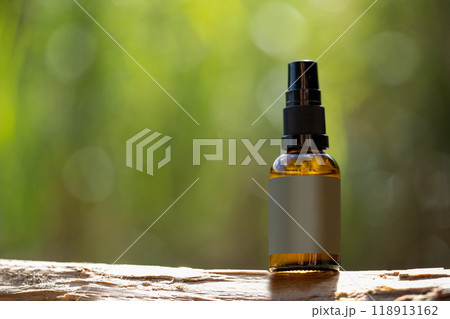 Amber Glass Spray Bottle on Wooden Surface Amber Glass Spray Bottle on Wooden Surface 118913162