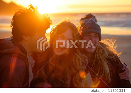 A group of friends laughing together on the beach at sunset, the warm glow of the evening sky reflecting the joy and optimism shared in their carefree moments 118913314