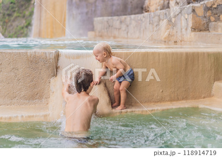 Toddler and teenage boys bathing in the hot springs of Grutas Tolantongo, Mexico. Family adventure, relaxation, and natural wellness concept Toddler and teenage boys bathing in the hot springs of Grutas Tolantongo, Mexico. Family adventure, relaxation, and natural wellness concept 118914719