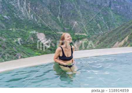 Female tourist at the hot springs of Grutas Tolantongo, Mexico. Adventure, relaxation, and natural wellness concept Female tourist at the hot springs of Grutas Tolantongo, Mexico. Adventure, relaxation, and natural wellness concept 118914859