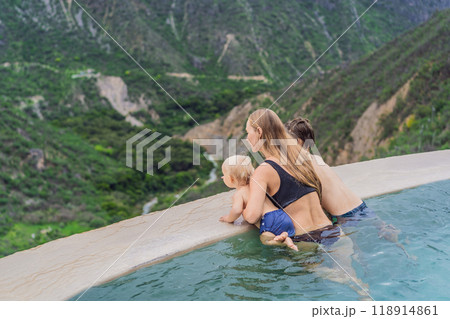Mother with her toddler and teenage sons bathing in the hot springs of Grutas Tolantongo, Mexico. Family adventure, relaxation, and natural wellness concept Mother with her toddler and teenage sons bathing in the hot springs of Grutas Tolantongo, Mexico. Family adventure, relaxation, and natural wellness concept 118914861