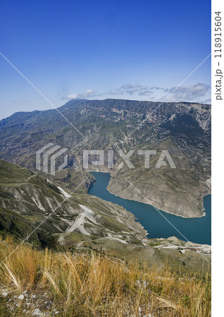 Beautiful panoramic view of the mountains with forests and blue-green river on a sunny summer day 118915604