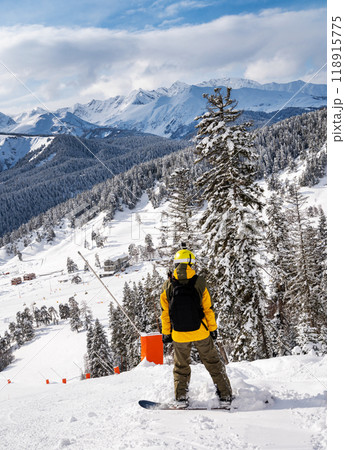 Beautiful landscape of the Arkhyz ski resort with mountains, snow, forest and man snowboarder Beautiful landscape of the Arkhyz ski resort with mountains, snow, forest and man snowboarder 118915775