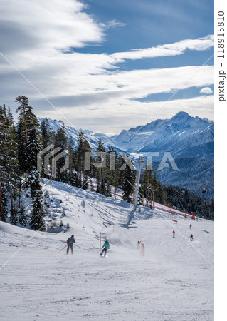 Beautiful landscape of the Arkhyz ski resort with mountains, snow, forest, skiers and snowboarders   Beautiful landscape of the Arkhyz ski resort with mountains, snow, forest, skiers and snowboarders   118915810