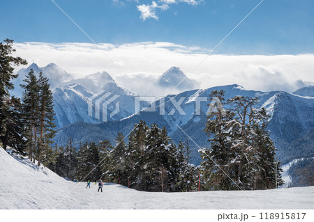 Beautiful landscape of the Arkhyz ski resort with mountains, snow, forest, skiers and snowboarders Beautiful landscape of the Arkhyz ski resort with mountains, snow, forest, skiers and snowboarders 118915817