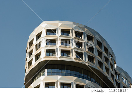 New building apartment with modern design. Minimal architecture skyscraper against blue cloudy sky. Vertical format. New building apartment with modern design. Minimal architecture skyscraper against blue cloudy sky. Vertical format. 118916124