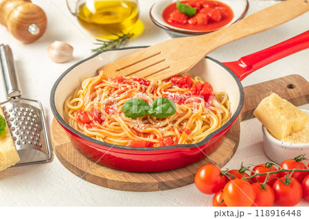 Spaghetti pasta in pan. Italian pasta with tomato sauce and basil 118916448