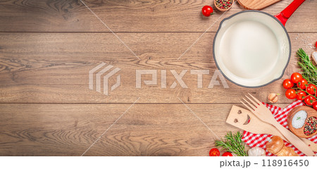 Cooking wooden board table. Background with spices, vegetables and pan. Long banner format. top view. copy space 118916450