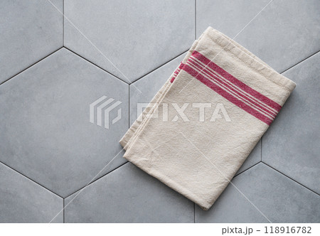 Empty kitchen napkin on gray ceramic tile in hexagon shape. 118916782
