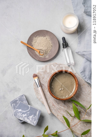 Organic cosmetic with blue clay on a marble board with brush, candle, soap and eucalyptus branch  118917052