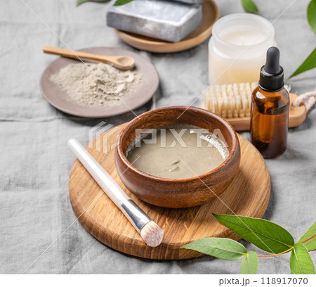 Organic cosmetic with blue clay, soap, brush, serum and candle on a linen background. 118917070