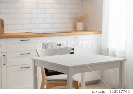 Empty wooden table with free space for product montage or mockup and chair Empty wooden table with free space for product montage or mockup and chair 118917760