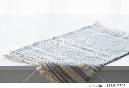 Wooden white empty tabletop with hanging napkin close up 118917795