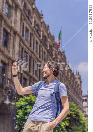 Male tourist in the central square of Mexico City, Zocalo. Cultural exploration, travel, and historic architecture concept 118917913