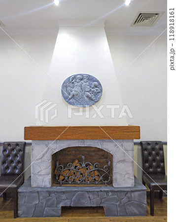 decorative fireplace with firewood in the banquet hall of the restaurant decorative fireplace with firewood in the banquet hall of the restaurant 118918161