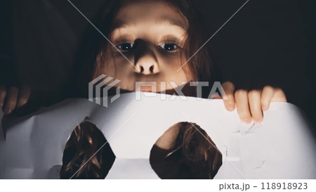 A blonde little girl scares off wearing DIY ghost costume for Halloween A blonde little girl scares off wearing DIY ghost costume for Halloween 118918923