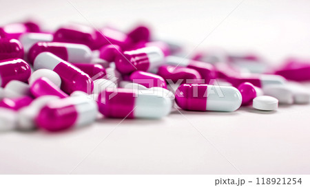 A pile of pink and white pills on a white background 118921254
