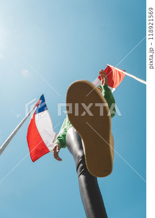 A woman at the border, the flags of Peru and Chile. Migration concept 118921569