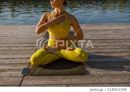 Engaging in a Yoga Practice by the Tranquil Water A Journey toward Serenity and Mindfulness Engaging in a Yoga Practice by the Tranquil Water A Journey toward Serenity and Mindfulness 118921599