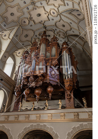 Ornate Pipe Organ in Church with Vaulted Ceiling and Intricate Wood Carvings - Architectural Marvel 118921716