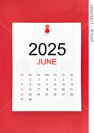 June 2025 calendar page with push pin on red background. June 2025 calendar page with push pin on red background. 118924085