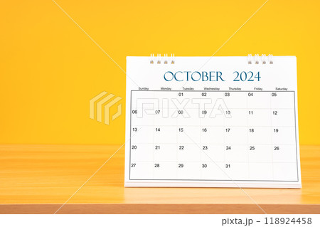 October 2024, Monthly desk calendar for 2024 year on wooden table on yellow background. October 2024, Monthly desk calendar for 2024 year on wooden table on yellow background. 118924458