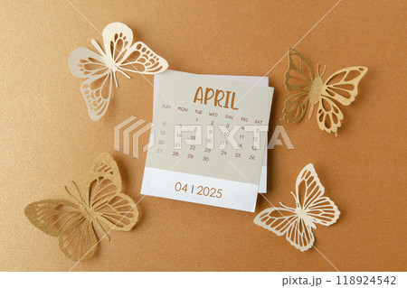 April 2025 calendar card with butterfly paper on orange. 118924542