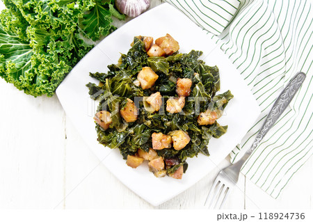 Kale cabbage with bacon in plate on light board top Kale cabbage with bacon in plate on light board top 118924736