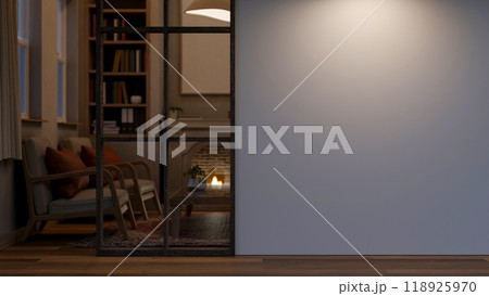 A home corridor leading through the cozy vintage living room at night features an empty white wall. 118925970