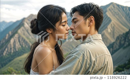 a romantic scene. A beautiful young Asian couple in love tenderly embraces against the backdrop of a mountain landscape. High quality photo 118926222