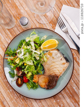 Roasted porbeagle steak with green salad and lemon Roasted porbeagle steak with green salad and lemon 118926710