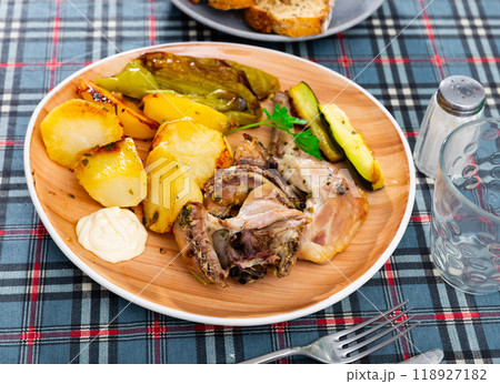 Roasted rabbit served with vegetable garnish Roasted rabbit served with vegetable garnish 118927182