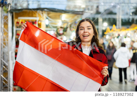 Happy girl with flag of Austria on street Christmas fair Happy girl with flag of Austria on street Christmas fair 118927302