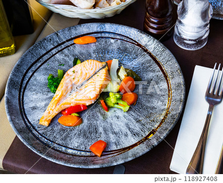 Salmon fish with vegetables served at plate with balsamic 118927408