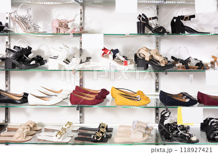 In shop window number of womens shoes of various brands with affordable price 118927421