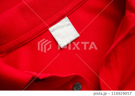 Blank white laundry care clothes label on red shirt fabric texture background Blank white laundry care clothes label on red shirt fabric texture background 118929057