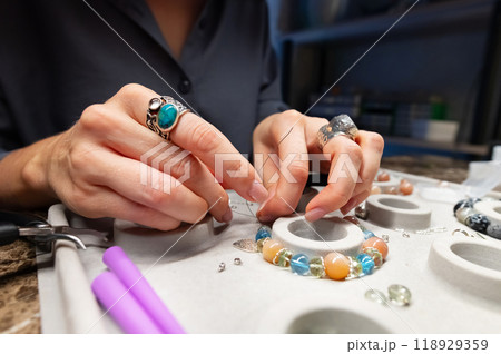 Craft jewelery making with professional tools. A handmade jeweler process, manufacture of jewellery Craft jewelery making with professional tools. A handmade jeweler process, manufacture of jewellery 118929359