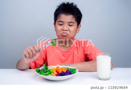 Children do not like to eat vegetables, Little cute boy refuses to eat healthy vegetables, Nutrition healthy eating habits for kids concept, Children do not like to eat vegetables. Children do not like to eat vegetables, Little cute boy refuses to eat healthy vegetables, Nutrition healthy eating habits for kids concept, Children do not like to eat vegetables. 118929684