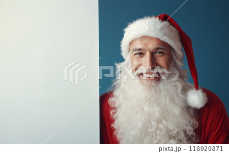 Santa Claus in festive red costume presenting blank banner for custom holiday message, blue background, ideal for Christmas promotions or advertisement Santa Claus in festive red costume presenting blank banner for custom holiday message, blue background, ideal for Christmas promotions or advertisement 118929871