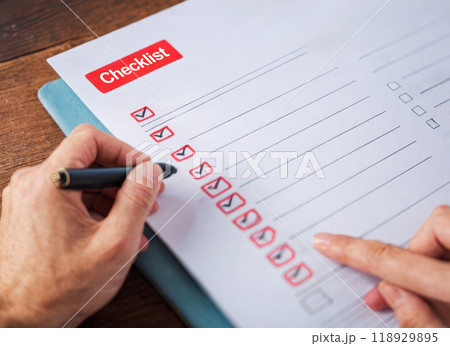 checklist. Close up view completing tasks on to-do list with red pen, productivity and efficient planning. red check marks in boxes on white checklist paper for task completion and organization 118929895
