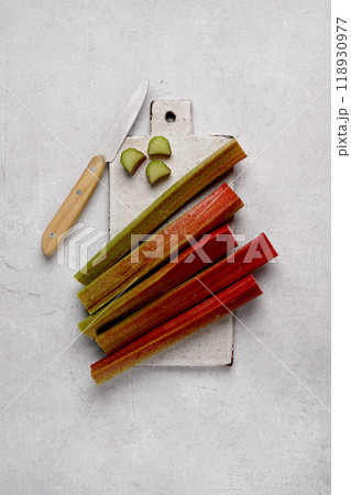 rhubarb on cutting board on gray background. top view, copy space. rhubarb on cutting board on gray background. top view, copy space. 118930977