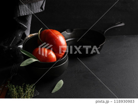 Big red tomato in black bowl. top view, copy space Big red tomato in black bowl. top view, copy space 118930983