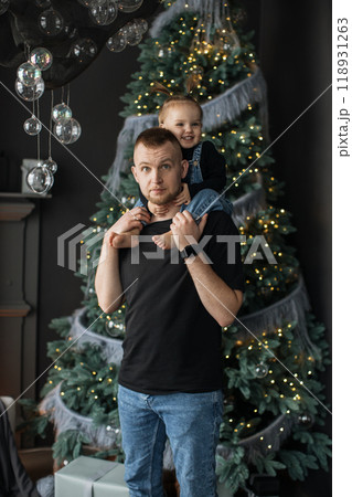 Father and daughter celebrating Christmas at home Father and daughter celebrating Christmas at home 118931263