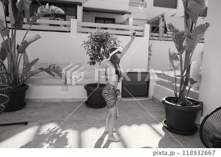 A graceful dancer moves gracefully in the warm sunlight amidst beautiful lush greenery A graceful dancer moves gracefully in the warm sunlight amidst beautiful lush greenery 118932667
