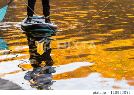 Paddleboarding in Autumn Serenity Paddleboarding in Autumn Serenity 118933053