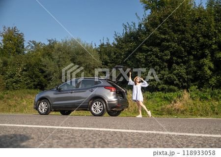 Woman Relaxing on SUV in Nature Woman Relaxing on SUV in Nature 118933058