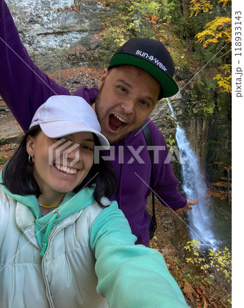 Couple Enjoying Nature by a Waterfall 118933143