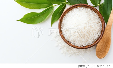 Bowl of white rice with green leaves on a white background 118935077