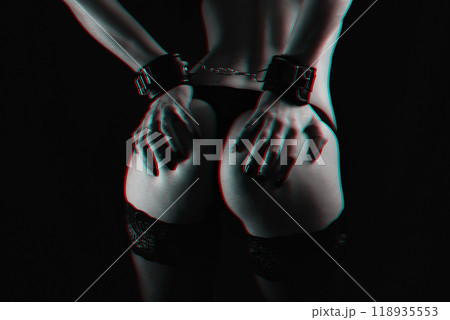 submissive girl in leather handcuffs for BDSM sex keeps her hands on her big sexy ass submissive girl in leather handcuffs for BDSM sex keeps her hands on her big sexy ass 118935553