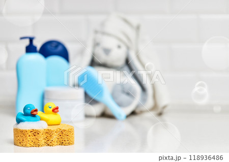 Yellow rubber duck, soap, bath foam on bath background, children bath accessories Yellow rubber duck, soap, bath foam on bath background, children bath accessories 118936486